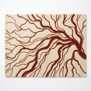 Abstract tree branch area rug featuring organic, flowing root and branch lines in deep rust terracotta on a soft cream background.